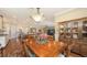 Open dining room with hardwood floors, elegant lighting, and a view into the gourmet kitchen and living room at 11176 Roseate Ct, Sarasota, FL 34238