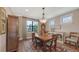 Formal dining room with hardwood floors, large window, elegant lighting, and classic furnishings at 11176 Roseate Ct, Sarasota, FL 34238