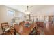 Open dining room with hardwood floors, elegant lighting, and a view into the gourmet kitchen at 11176 Roseate Ct, Sarasota, FL 34238