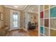 Entryway featuring hardwood floors, decorative glass door, and view into the living room at 11176 Roseate Ct, Sarasota, FL 34238