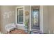 Inviting front entrance features a decorative glass door, chair and potted plant at 11176 Roseate Ct, Sarasota, FL 34238