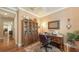 Inviting home office featuring hardwood floors, built-in bookshelves, and a comfortable workspace at 11176 Roseate Ct, Sarasota, FL 34238