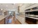 Gourmet kitchen featuring stainless steel appliances, granite countertops, and hardwood flooring at 11176 Roseate Ct, Sarasota, FL 34238