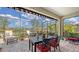 Charming lanai providing a relaxing outdoor experience with comfortable seating, a dining area, and scenic water views at 11176 Roseate Ct, Sarasota, FL 34238