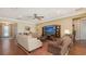 Cozy living room featuring hardwood floors, comfortable seating, and recessed lighting at 11176 Roseate Ct, Sarasota, FL 34238