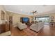 Bright living room with hardwood floors, neutral furniture, and sliding glass doors at 11176 Roseate Ct, Sarasota, FL 34238