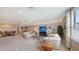 Expansive living area with couches, a TV, and a dining space, perfect for entertaining guests at 11176 Roseate Ct, Sarasota, FL 34238