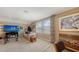 Open living area with a TV, cozy seating, and large windows offering views at 11176 Roseate Ct, Sarasota, FL 34238