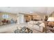 Bright and airy living space featuring comfortable seating, a coffee table, and a dining area at 11176 Roseate Ct, Sarasota, FL 34238