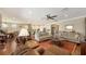 Inviting living area features a hardwood floor, a large sofa, and an open plan to kitchen and dining at 11176 Roseate Ct, Sarasota, FL 34238