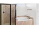 Elegant bathroom features glass shower, garden tub, and tiled surround at 11214 Sandhill Preserve Dr, Sarasota, FL 34238