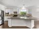 Bright kitchen boasts granite countertops, stainless steel appliances, and a large center island at 11214 Sandhill Preserve Dr, Sarasota, FL 34238