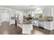 Modern kitchen featuring white cabinets, granite countertops, stainless steel appliances, and hardwood floors at 11214 Sandhill Preserve Dr, Sarasota, FL 34238