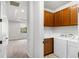 Laundry room with washer, dryer, utility sink, and overhead cabinets at 11214 Sandhill Preserve Dr, Sarasota, FL 34238