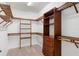 Walk-in closet with wood shelving and storage at 11214 Sandhill Preserve Dr, Sarasota, FL 34238