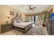 Bright bedroom features a large bed, wood floors, light-colored walls, and access to the outdoor space at 113 Fillmore Dr, Sarasota, FL 34236