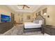 Neutral-toned bedroom featuring a large bed, wooden furnishings, and a view into the hallway at 113 Fillmore Dr, Sarasota, FL 34236