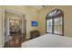 Bedroom with hardwood floors, a television, and a view into a dining area at 113 Fillmore Dr, Sarasota, FL 34236