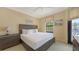 Comfortable bedroom boasts natural light and a balcony to enjoy the outdoor air at 113 Fillmore Dr, Sarasota, FL 34236