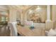 Light and airy dining room featuring a large decorative mirror and an antique-style wooden table at 113 Fillmore Dr, Sarasota, FL 34236