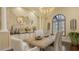 Bright dining room featuring textured walls, statement lighting, and a wooden table with seating for six at 113 Fillmore Dr, Sarasota, FL 34236