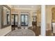 Open foyer with dark wood floors, arched doorways, and french doors leading to the outdoor living space at 113 Fillmore Dr, Sarasota, FL 34236