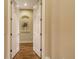 Hallway with hardwood floors, neutral-colored walls, and arched wall niches at 113 Fillmore Dr, Sarasota, FL 34236
