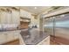 Bright kitchen featuring cream cabinets, stone tile backsplash, stainless steel appliances, and a large kitchen island at 113 Fillmore Dr, Sarasota, FL 34236
