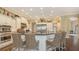 Open kitchen with a large island, barstool seating, stainless steel appliances, and custom cabinetry at 113 Fillmore Dr, Sarasota, FL 34236