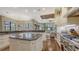 Spacious kitchen with an island, stainless steel appliances, and a breakfast bar overlooking a living area at 113 Fillmore Dr, Sarasota, FL 34236