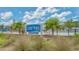 Close up showing Lido Pool sign for pool newly renovated and heated behind some beach grass at 113 Fillmore Dr, Sarasota, FL 34236