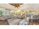 Open-concept living room and kitchen with large gray sectional and breakfast bar at 113 Fillmore Dr, Sarasota, FL 34236