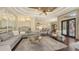 Spacious living room with tray ceiling, large gray sectional, and natural light at 113 Fillmore Dr, Sarasota, FL 34236