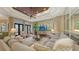 Comfortable living room with gray sectional, large windows, and access to the backyard at 113 Fillmore Dr, Sarasota, FL 34236