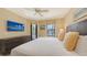 Bright main bedroom featuring a king bed, balcony, and mounted TV for ultimate comfort at 113 Fillmore Dr, Sarasota, FL 34236