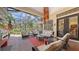 Relaxing outdoor living area with seating, grill, and screened-in views of lush landscaping at 113 Fillmore Dr, Sarasota, FL 34236