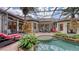 Outdoor patio area featuring a pool, spa, landscaping, and an under-cover outdoor kitchen, and dining area at 113 Fillmore Dr, Sarasota, FL 34236