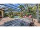 Enclosed pool and patio with table and chairs, perfect for outdoor dining and relaxation at 113 Fillmore Dr, Sarasota, FL 34236
