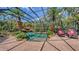 Serene screened pool area with waterfall, lush tropical plants, and comfortable lounge chairs at 113 Fillmore Dr, Sarasota, FL 34236