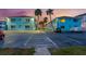 Exterior shot of apartment complex with parking and palm trees at sunset at 117 7Th N St # 35, Bradenton Beach, FL 34217