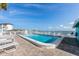 Community pool area offering ocean views, ample seating and lounge chairs at 117 7Th N St # 35, Bradenton Beach, FL 34217