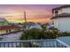 Stunning water view from the porch of this beachfront home at sunset, surrounded by lush tropical foliage at 117 7Th N St # 35, Bradenton Beach, FL 34217