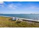 Scenic waterfront view with comfortable Adirondack chairs for relaxation and enjoying the scenery at 117 7Th N St # 35, Bradenton Beach, FL 34217