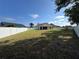 The large backyard is surrounded by a white privacy fence at 11811 53Rd Ct E, Parrish, FL 34219