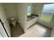 Bathroom featuring double sinks, white cabinets, and natural light at 11811 53Rd Ct E, Parrish, FL 34219