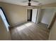 Bedroom with wood flooring, a ceiling fan, and closet at 11811 53Rd Ct E, Parrish, FL 34219