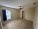 Bedroom with wood flooring, a ceiling fan, and a closet at 11811 53Rd Ct E, Parrish, FL 34219