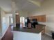 Well-lit kitchen with tile floors, wood cabinets, and an open view to living area at 11811 53Rd Ct E, Parrish, FL 34219