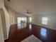 Open living room with hardwood floors leads to a screened patio, filled with natural light at 11811 53Rd Ct E, Parrish, FL 34219