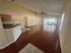 Bright living room with hardwood floors, seamlessly connects to the kitchen and outdoor patio at 11811 53Rd Ct E, Parrish, FL 34219